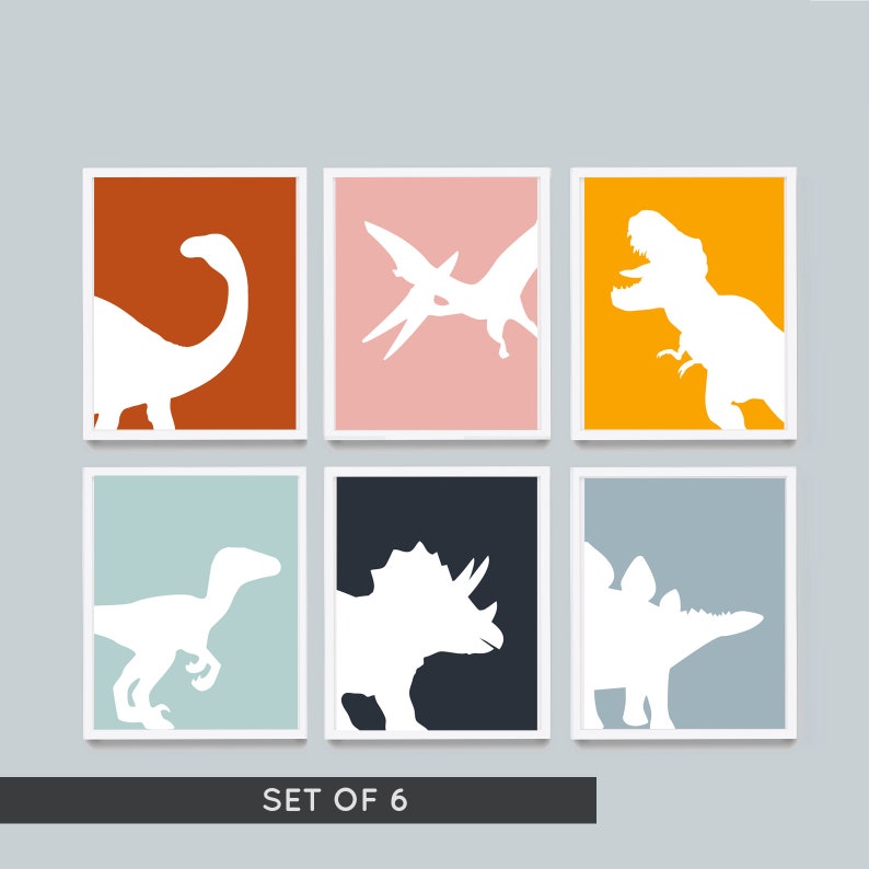 May include: Set of six printable dinosaur silhouette wall art prints. Each print features a different dinosaur silhouette in white against a colorful background. The colors include orange, pink, yellow, blue, gray, and black.