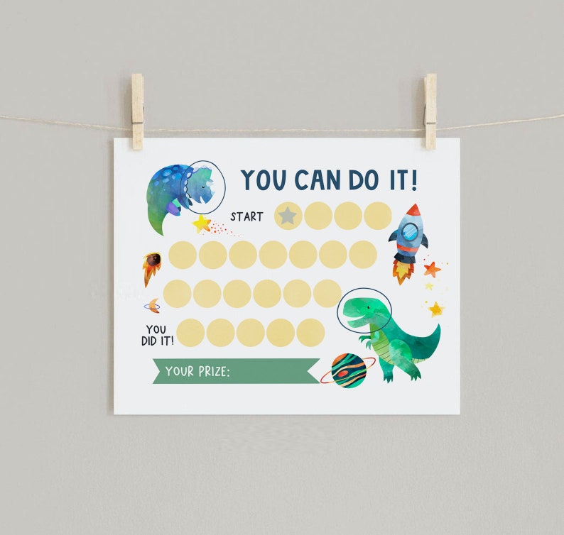 May include: A printable space-themed reward chart with a dinosaur, rocket, and planets. The chart has a title "YOU CAN DO IT!" and says "YOU DID IT!" and "YOUR PRIZE:" at the bottom. There are 20 circles to color in.