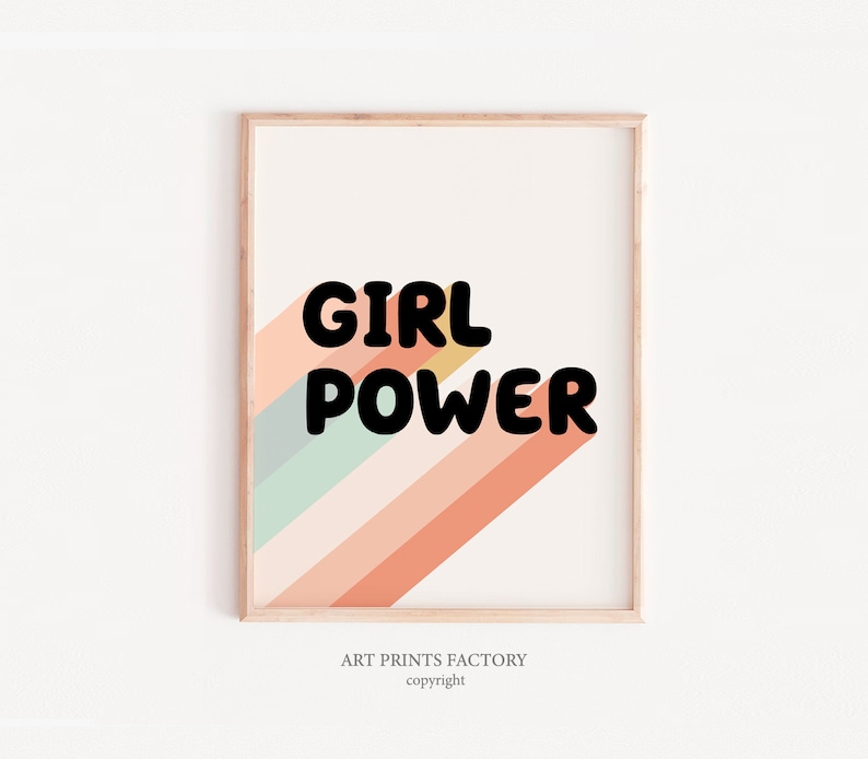 May include: A framed print with a colourful striped background and the text "GIRL POWER" in black bold letters. The print has a light wood frame.