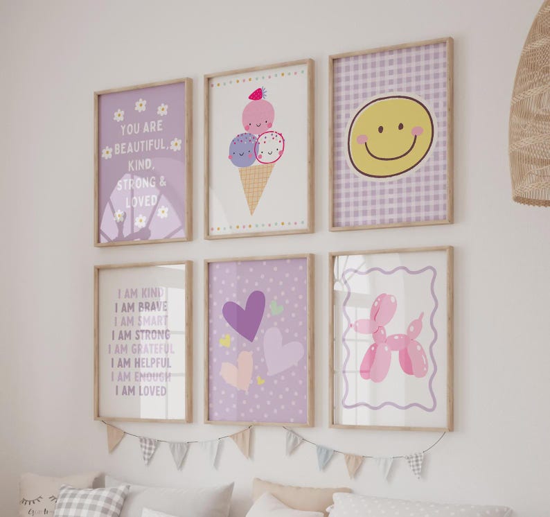 May include: A set of six framed wall art prints featuring various designs including a purple poster with white text reading You Are Beautiful Kind Strong & Loved, an ice cream cone, a yellow smiley face, positive affirmations, hearts, and a balloon dog.