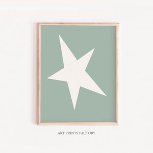 May include: A framed print featuring a white star on a sage green background. The print includes the text "ART PRINTS FACTORY" at the bottom.