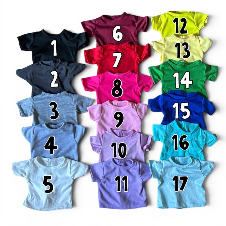 May include: A collection of seventeen short-sleeved t-shirts in various solid colors, each labeled with a white number from 1 to 17. The shirts are arranged in a grid, featuring shades of black, gray, red, pink, purple, blue, green, and yellow.