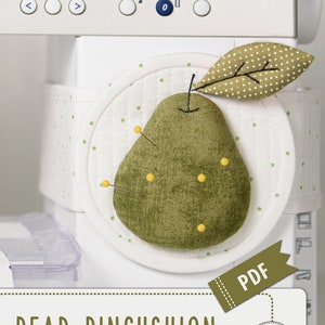 May include: A green pear-shaped pincushion with a green leaf and yellow polka dots. The pincushion is sitting on a white sewing machine with a white background. The text "PEAR PINCUSHION SEWING PATTERN & TUTORIAL" is below the pincushion. The text "PDF" is on a green tag attached to the pincushion. The text "Blue Owl Land" is in a circle below the pincushion.