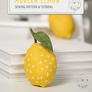 May include: A sewing pattern and tutorial for making a modern lemon plush toy. The pattern includes instructions for creating a yellow lemon with white plus signs and a green leaf.