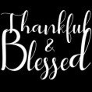May include: White text on a black background reads "Thankful & Blessed".
