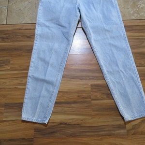 May include: Light blue denim jeans with a straight leg fit.