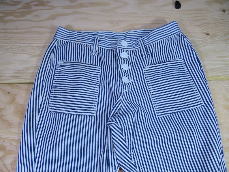 May include: Blue and white striped pants with two front pockets and a button fly.