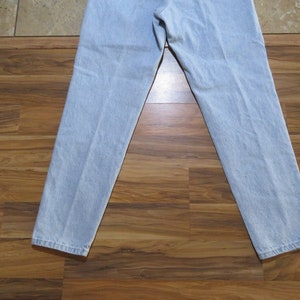 May include: A pair of light blue denim jeans with a straight leg fit.