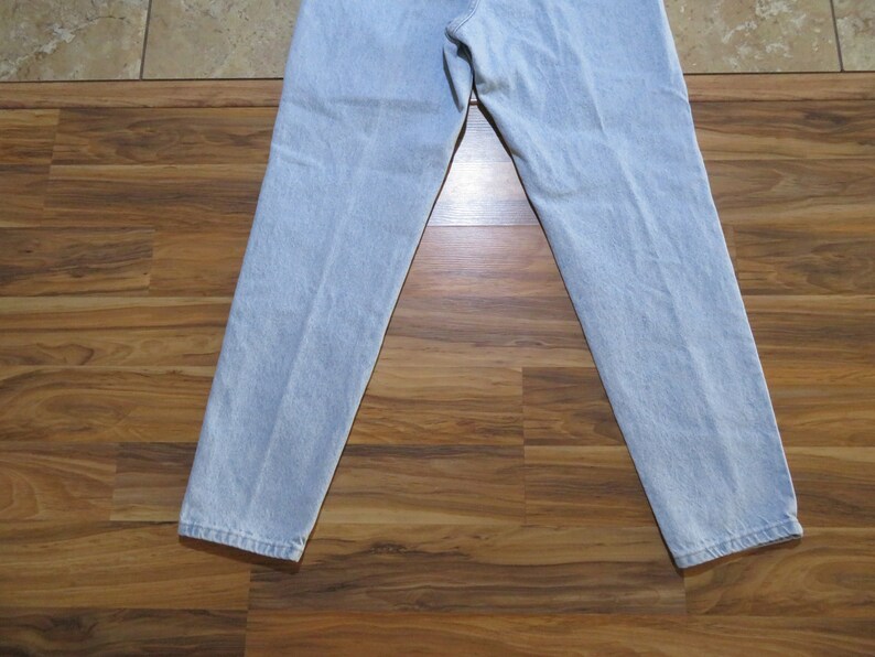 May include: A pair of light blue denim jeans with a straight leg fit.