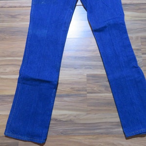 May include: A pair of blue denim jeans with a straight leg fit.