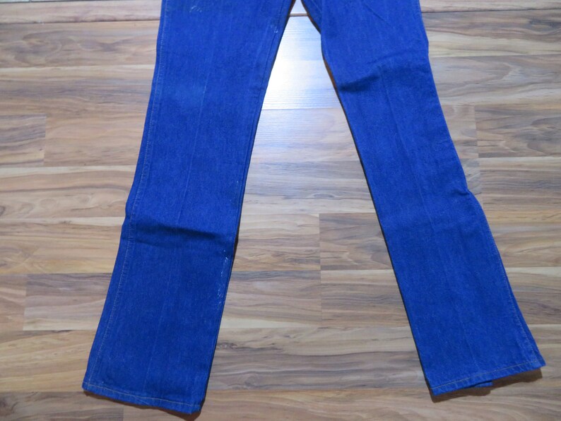 May include: A pair of blue denim jeans with a straight leg fit.