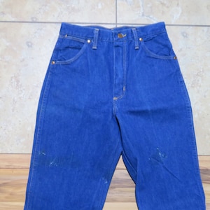 May include: A pair of blue denim jeans with a high waist and a straight leg.