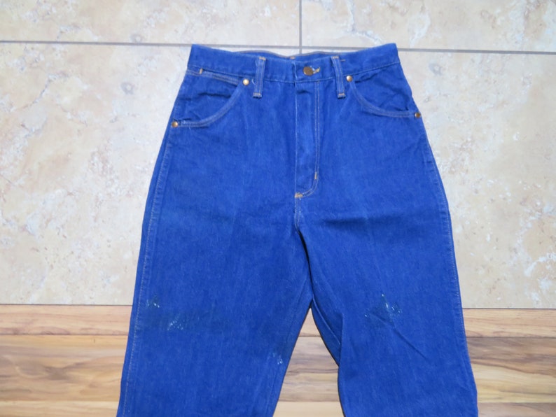 May include: A pair of blue denim jeans with a high waist and a straight leg.
