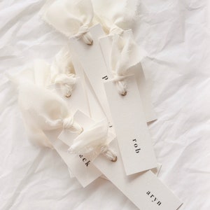 Modern place cards with ribbon attached, bold text escort cards, black and white name cards image 2