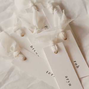 Modern place cards with ribbon attached, bold text escort cards, black and white name cards image 6