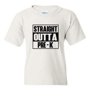 May include: A white t-shirt with the text "STRAIGHT OUTTA PRE-K" in a black box. The shirt is short-sleeved and appears to be made of cotton. The text is centered on the front of the shirt.