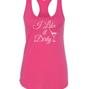 May include: A bright pink racerback tank top with the text "I Like it Dirty" in white script and a martini glass graphic. The tank top has a scoop neck and a sleeveless design.