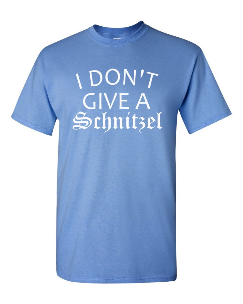 May include: A light blue t-shirt with the text "I don't give a Schnitzel" printed in white.