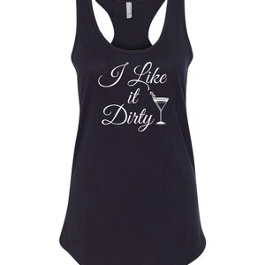 May include: A navy blue racerback tank top with the phrase "I Like it Dirty" in white script, accompanied by a martini glass illustration. The tank top has a scoop neck and a curved hemline.