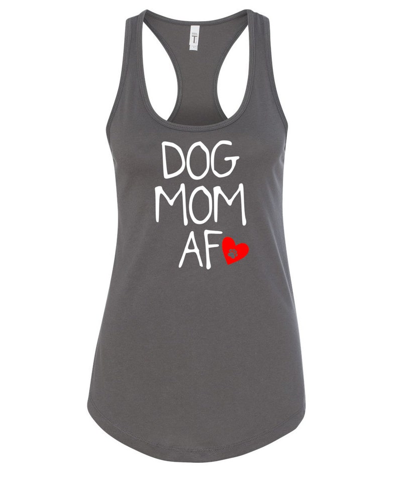 May include: A charcoal gray racerback tank top with the words "DOG MOM AF" in white, and a red heart graphic. The tank top has a scoop neck and a curved hemline. The shirt is made of a soft material.