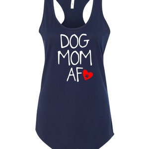 May include: Navy blue tank top with a racerback design. The white text reads "DOG MOM AF" with a red heart and paw print graphic. A casual, comfortable top for dog lovers.