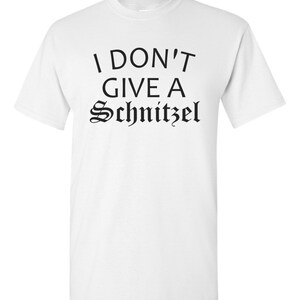 May include: White t-shirt with black text that reads "I don't give a Schnitzel".