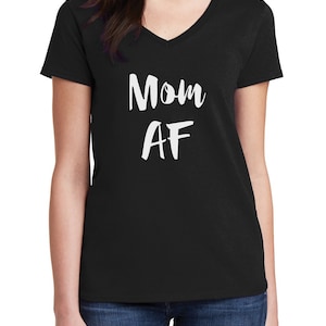 May include: Black V-neck t-shirt with the white text "Mom AF". The shirt is made of a soft material and is suitable for casual wear. A simple and bold design for mothers.