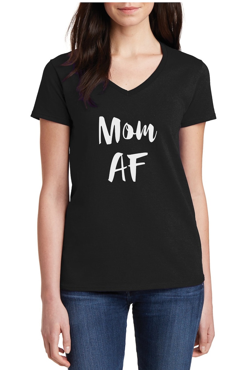 May include: Black V-neck t-shirt with the white text "Mom AF". The shirt is made of a soft material and is suitable for casual wear. A simple and bold design for mothers.