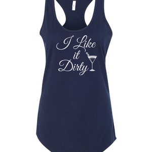 May include: Navy blue racerback tank top with the phrase "I Like it Dirty" in white script, accompanied by a martini glass illustration. The tank top has a scoop neck and a curved hemline.