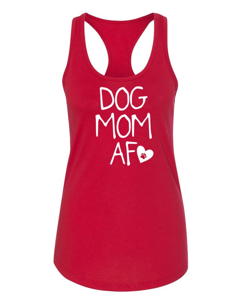 May include: A red racerback tank top with the words "DOG MOM AF" in white, along with a white heart and paw print graphic. The tank top has a scoop neck and a sleeveless design.