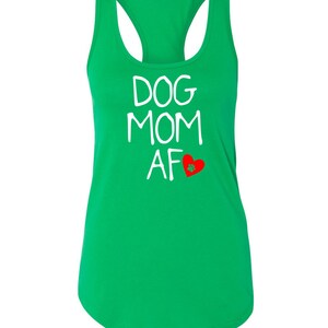 May include: A bright green racerback tank top with the words "DOG MOM AF" in white, and a red heart with a paw print. The tank top is made of a soft material and is perfect for dog lovers.