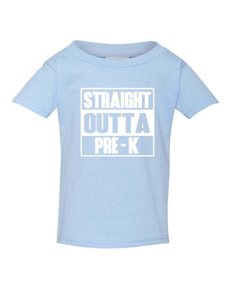 May include: A light blue toddler t-shirt with the text "STRAIGHT OUTTA PRE-K" in white block letters. The text is centered on the front of the shirt. The shirt has short sleeves and a crew neck.