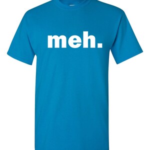 May include: A turquoise blue t-shirt with the word "meh." printed in large, white, sans-serif letters across the chest. The shirt has short sleeves and a crew neck.