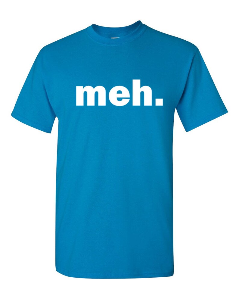 May include: A turquoise blue t-shirt with the word "meh." printed in large, white, sans-serif letters across the chest. The shirt has short sleeves and a crew neck.