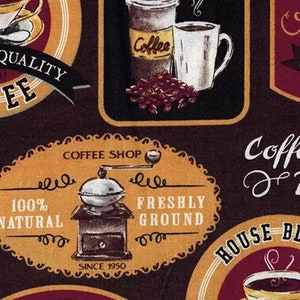May include: A brown and yellow coffee shop sign with the text "Coffee Shop" and "Freshly Ground" in a white oval. The sign also includes a black and white illustration of a coffee grinder with the text "100% Natural" and "Since 1950".