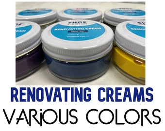 Könnte beinhalten: Schuhcreme-Gläser in verschiedenen Farben, darunter Lila, Blau, Gelb und Weiß. Die Gläser sind mit "Shoe Doctor Renovating Cream" und "50ml Net" beschriftet.