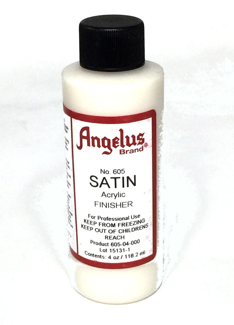 May include: A white bottle of Angelus Brand Satin Acrylic Finisher. The bottle is labeled with the product name, number, and instructions for use. It contains 4 ounces or 118.2 milliliters of product.
