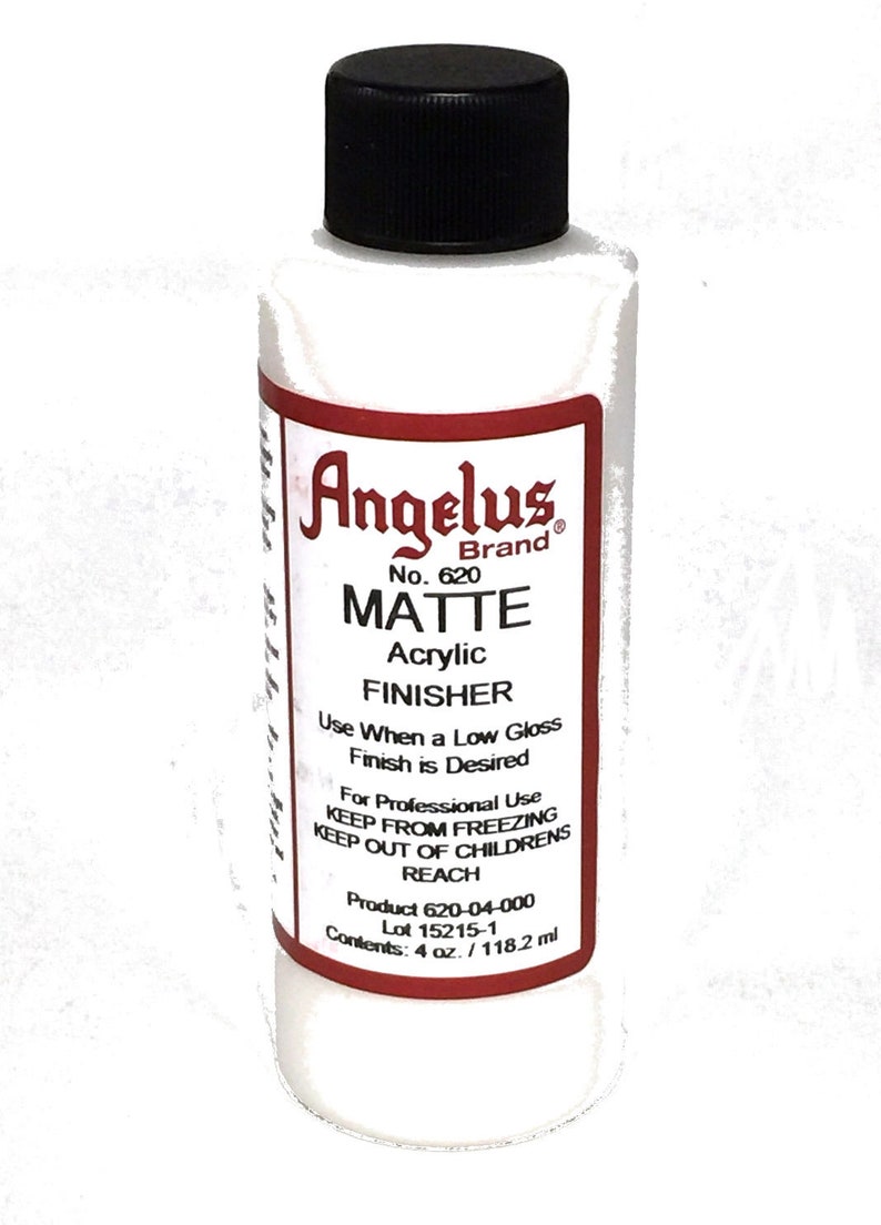 May include: A 4-ounce bottle of Angelus Brand Matte Acrylic Finisher. The bottle is white with a red label that says "Angelus Brand" and "Matte Acrylic Finisher". The label also includes the product number 620, instructions for use, and the product's lot number.
