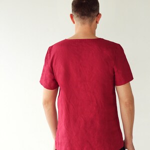 May include: A burgundy short-sleeved shirt with a scoop neck.