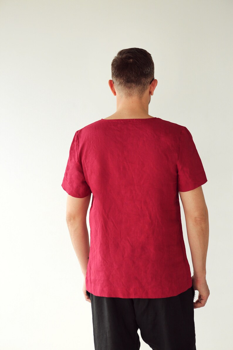 May include: A burgundy short-sleeved shirt with a scoop neck.