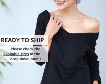 May include: Black off-the-shoulder top and matching shorts. The top has long sleeves and a wide neckline. The text "READY TO SHIP" is visible, along with a prompt to check available sizes in the drop-down menu.