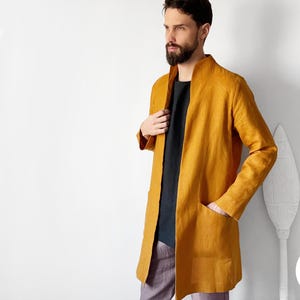 May include: Mustard yellow linen jacket with long sleeves and two front pockets. The jacket is open, revealing a black shirt underneath. The model is wearing purple pants. The text "UPDATED SIZING CHART" is in the bottom right corner.