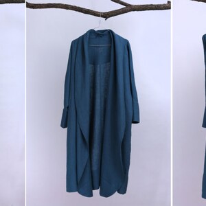 May include: Five long-sleeved, teal blue wrap dresses with a tie at the waist. The dresses are hanging on hangers against a white background.
