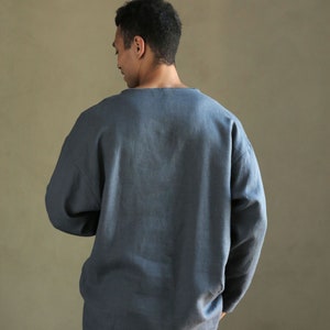 May include: A blue long-sleeved shirt with a relaxed fit and a crew neck.