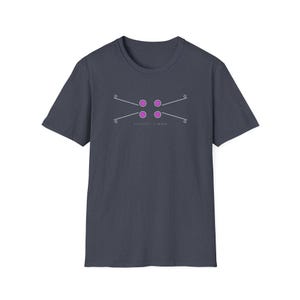 May include: Dark navy blue t-shirt with a geometric design. The design features four pink circles and thin white lines. The text "ESTABLISHED 1999" is printed below the design. The t-shirt is made of a soft material.