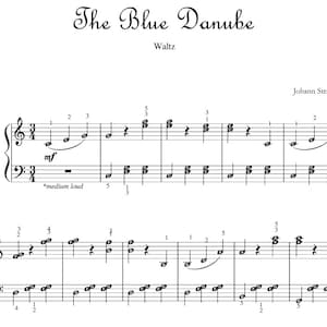 May include: Sheet music for the waltz "The Blue Danube" by Johann Strauss II. The music is written in standard notation with a treble clef and bass clef. The title of the piece is written in cursive script at the top of the page.