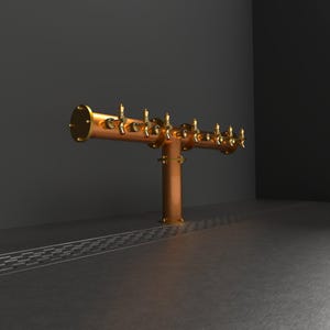May include: A copper beer tap system with eight gold spouts. The tap system is mounted on a black wall and has a drain in front of it.
