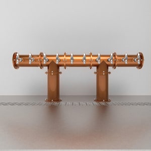 May include: A copper beer tap system with 10 taps, mounted on a wall. The taps are all in a row and are connected to a copper pipe.