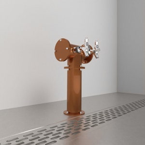 May include: A copper beer tap with two chrome spouts. The tap is mounted on a metal stand with a drain grate in the foreground.