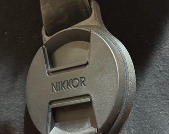 Lens cap holder for 67, 72, 77, and 82mm caps, good for 45mm Strap